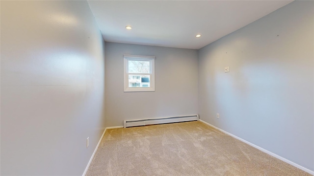 spare room with a baseboard radiator and light colored carpet