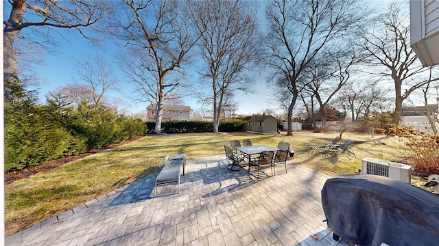 view of patio featuring a storage shed and central AC unit