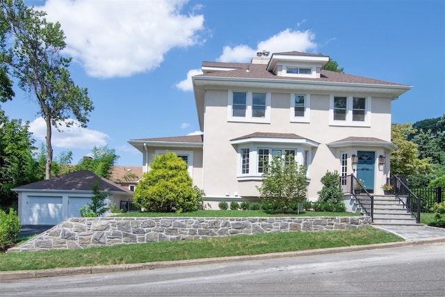 view of front of house with a garage and an outdoor structure