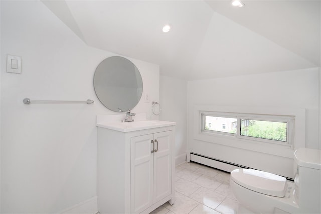 bathroom featuring vanity, lofted ceiling, tile patterned flooring, toilet, and a baseboard radiator