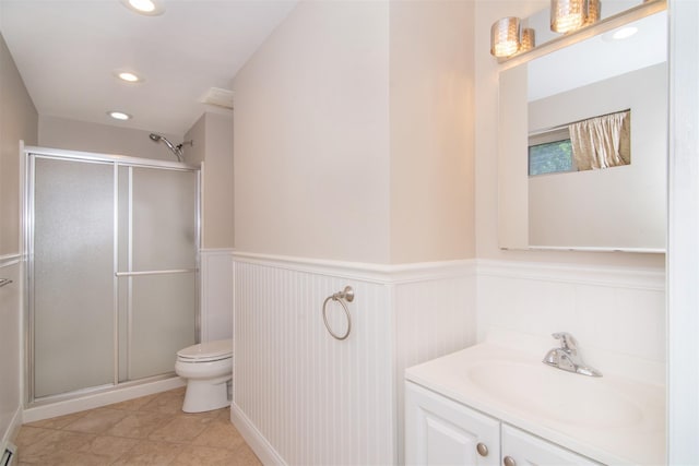 bathroom with vanity, a shower with shower door, and toilet