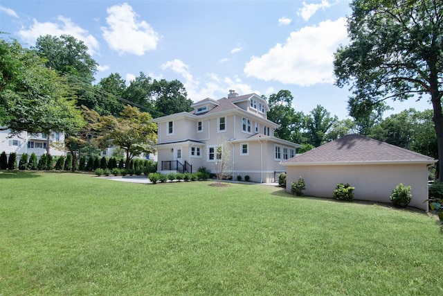 rear view of house featuring a lawn