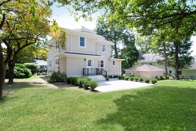 rear view of property with a yard