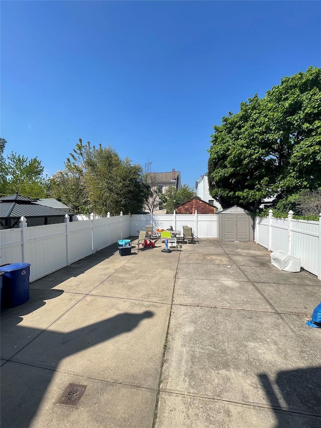 view of patio featuring a storage shed