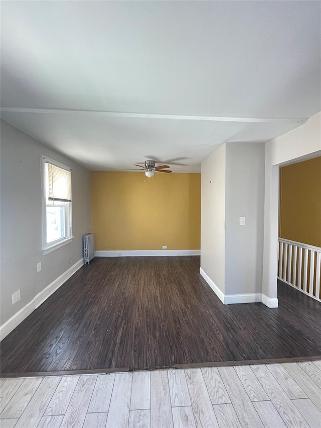 spare room with radiator, ceiling fan, and hardwood / wood-style flooring