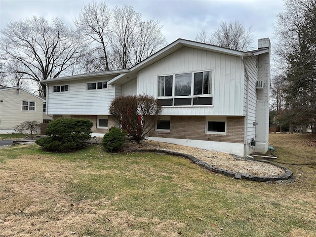 back of house with a lawn