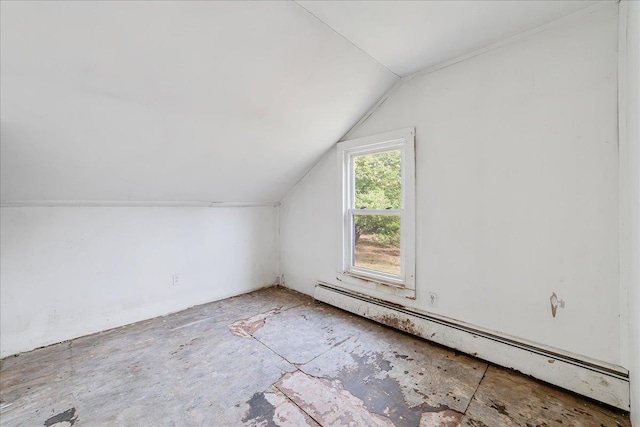 additional living space featuring lofted ceiling and a baseboard heating unit