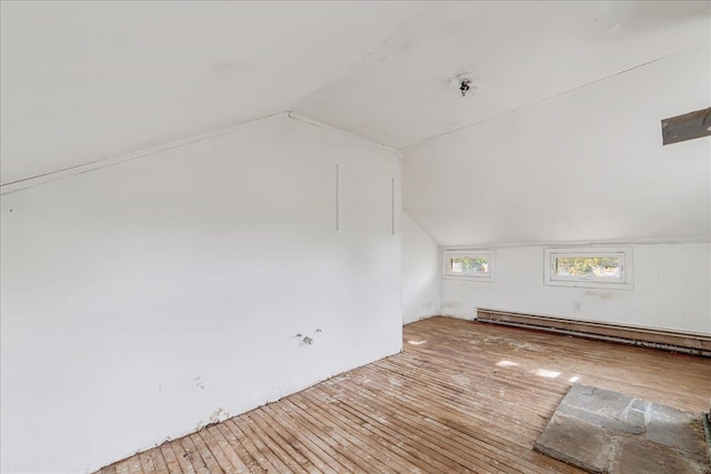 bonus room featuring hardwood / wood-style floors, lofted ceiling, and a baseboard radiator