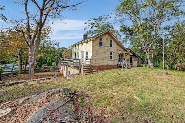 view of property exterior featuring a lawn and a wooden deck