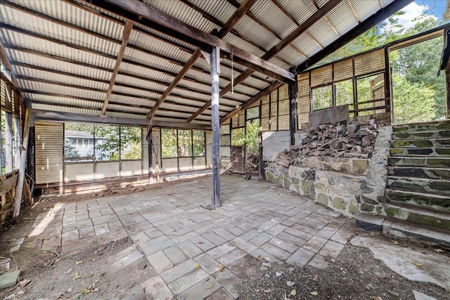 unfurnished sunroom with lofted ceiling