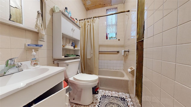 full bathroom featuring vanity, shower / bath combination with curtain, toilet, and tile walls