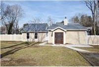 ranch-style home with a front lawn