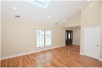 empty room with a skylight and wood-type flooring