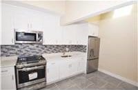 kitchen with white cabinetry and range