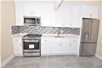 kitchen featuring tile patterned floors, white cabinetry, stainless steel fridge with ice dispenser, and range