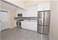 kitchen featuring white cabinetry, sink, stainless steel fridge with ice dispenser, light tile patterned floors, and range