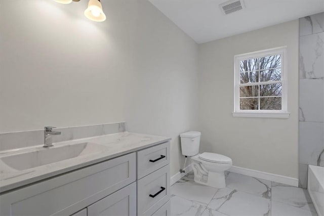 bathroom with vanity, a bath, and toilet