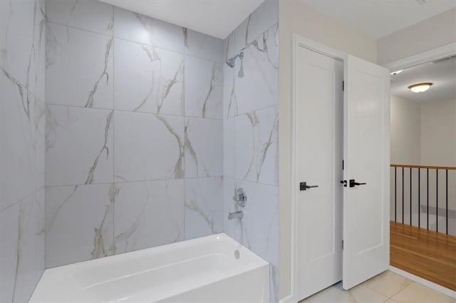 bathroom featuring tile patterned flooring and tiled shower / bath combo