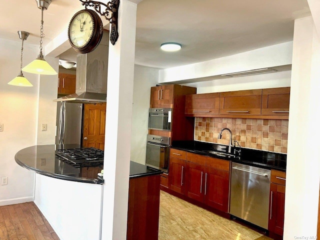 kitchen featuring backsplash, sink, decorative light fixtures, light hardwood / wood-style floors, and stainless steel appliances