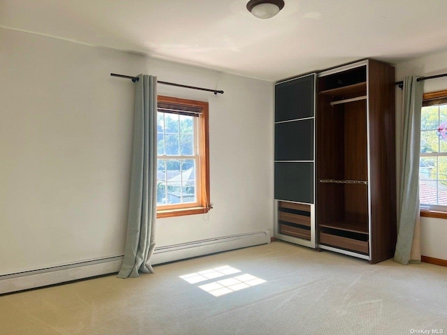 unfurnished bedroom with a closet, light colored carpet, and a baseboard radiator