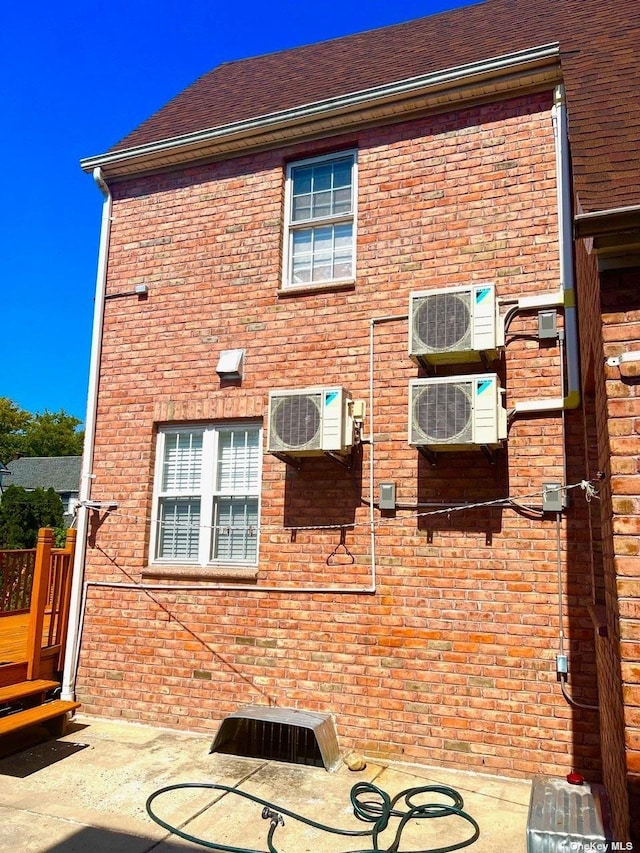 rear view of house featuring ac unit