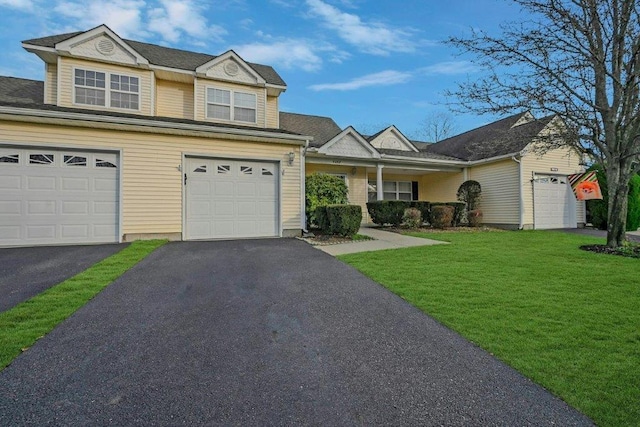 view of front of home with a front yard and a garage