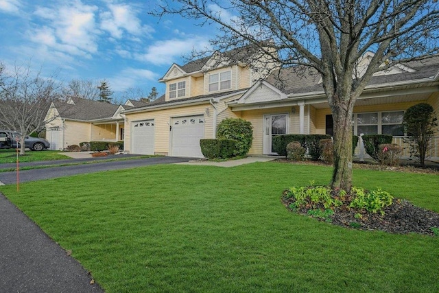 view of front of home with a garage and a front yard