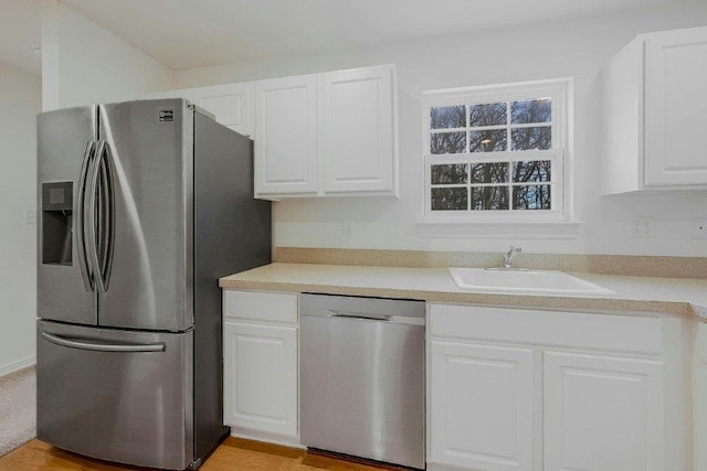 kitchen with white cabinets, stainless steel appliances, and sink