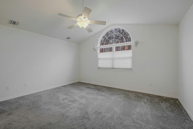 empty room featuring ceiling fan, carpet floors, and vaulted ceiling