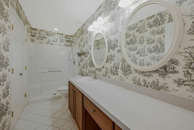 bathroom with tile patterned flooring, vanity, toilet, and tiled shower