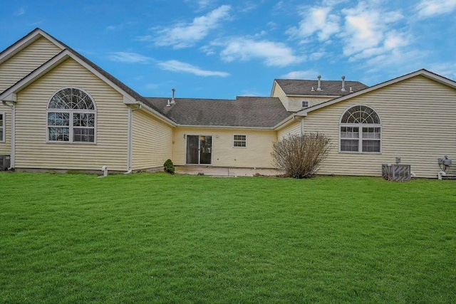 rear view of property with a lawn