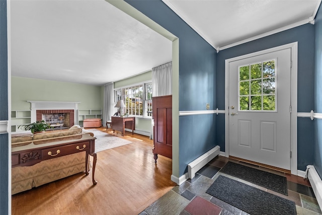 17 Walnut Hill Rd, Poughkeepsie, NY 12603 - foyer with a baseboard radiator, a brick fireplace, crown molding, baseboard heating, and wood finished floors