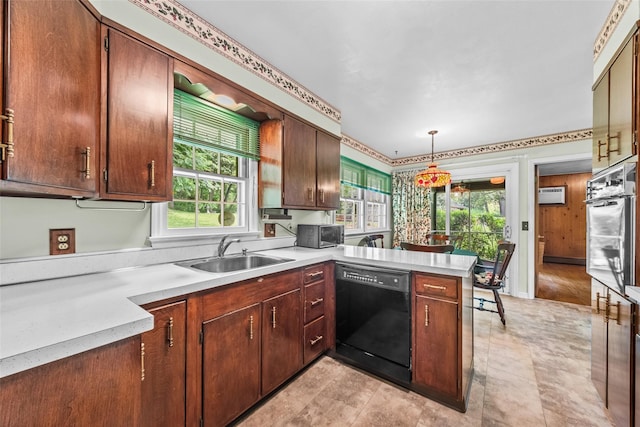 17 Walnut Hill Rd, Poughkeepsie, NY 12603 - kitchen with black dishwasher, stainless steel oven, a peninsula, light countertops, and decorative light fixtures
