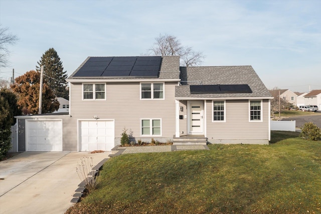 tri-level home with solar panels, a garage, and a front yard