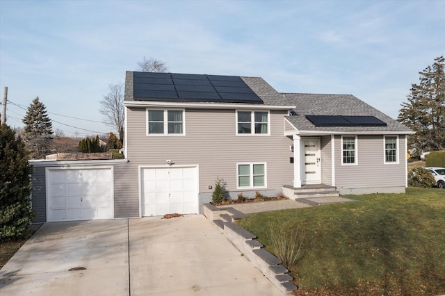 view of front of property with solar panels, a front yard, and a garage