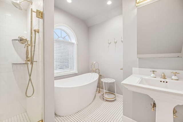 bathroom featuring plus walk in shower, lofted ceiling, and sink