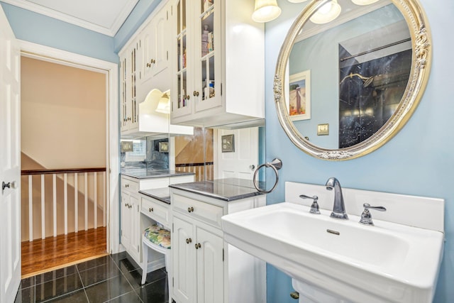 bathroom with decorative backsplash, sink, ornamental molding, and tile patterned flooring