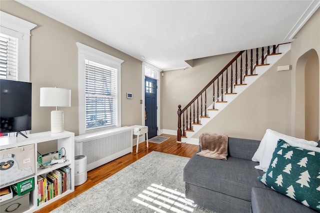 living room featuring radiator heating unit and hardwood / wood-style floors