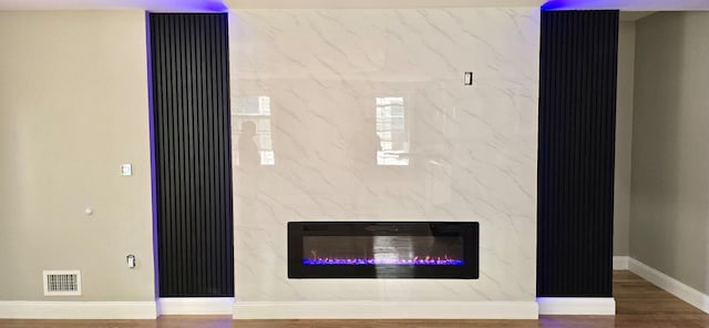 interior details featuring wood-type flooring and a fireplace