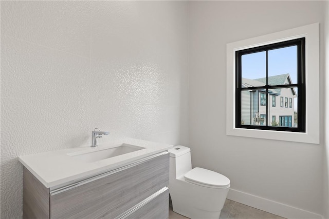 bathroom featuring tile patterned flooring, vanity, and toilet