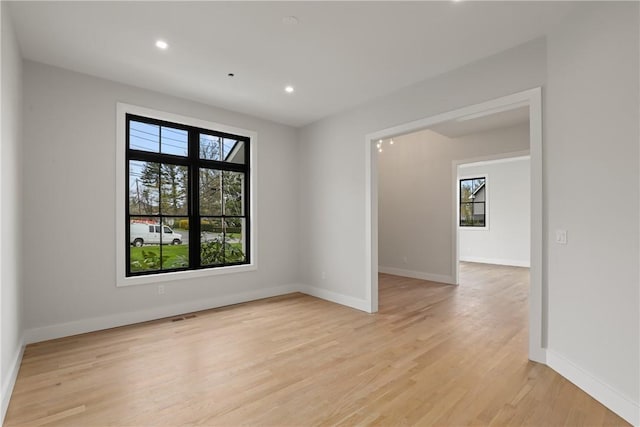 empty room with light hardwood / wood-style flooring