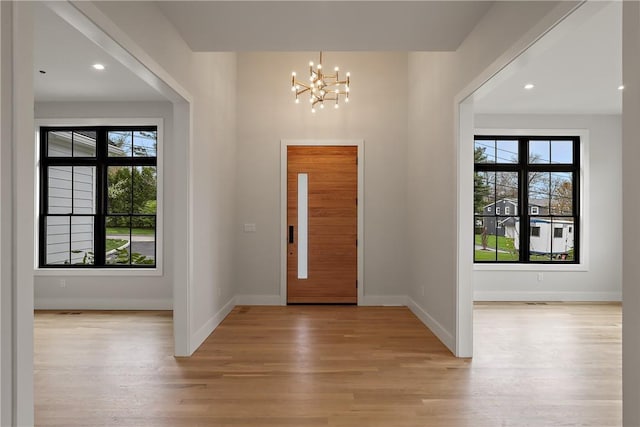 entryway featuring a chandelier and light wood-type flooring