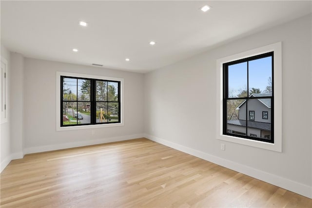 spare room with light hardwood / wood-style floors