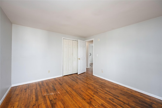 unfurnished bedroom featuring dark hardwood / wood-style floors