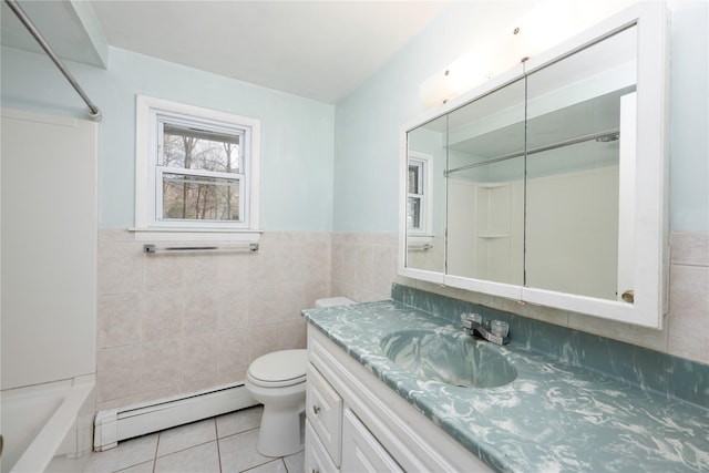 full bathroom with baseboard heating, tile patterned floors, vanity, and tile walls