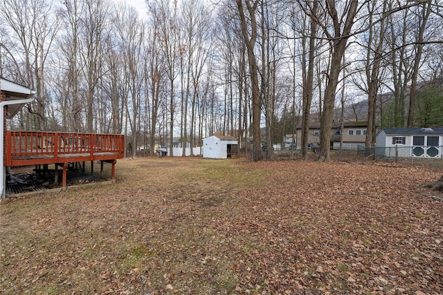 view of yard with a deck and a storage shed