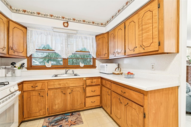 kitchen featuring sink and white appliances