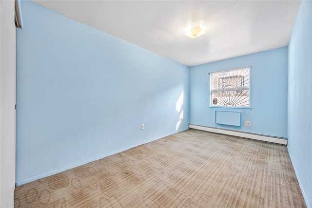 carpeted spare room featuring a baseboard radiator