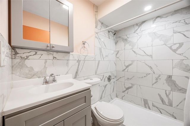 bathroom featuring a tile shower, vanity, tile walls, and toilet