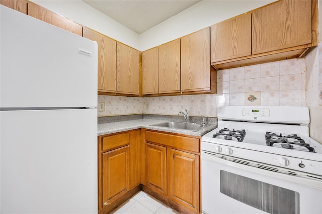 kitchen featuring decorative backsplash, sink, light tile patterned floors, and white appliances